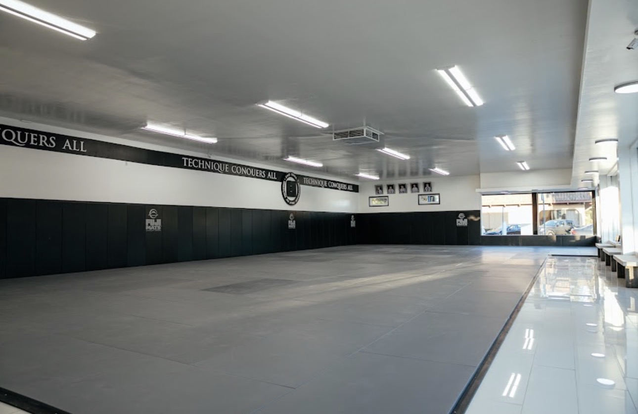 Completed commercial lighting across a Caio Terra Academy training floor